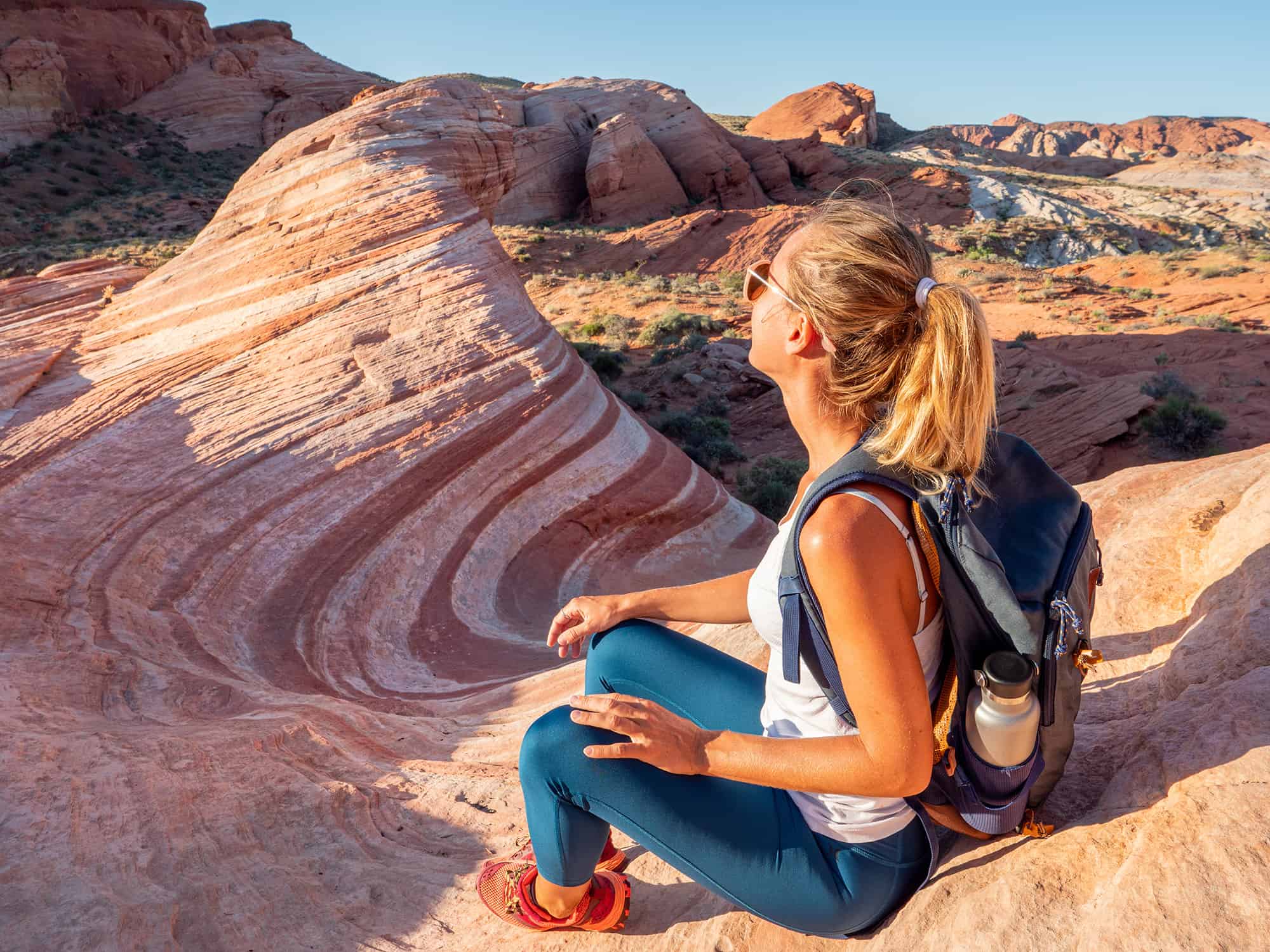 Hiker woman contemplating red sandstone